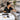 A serene and organized spa treatment room featuring stylish, standardized storage solutions, including a clean, mobile cabinet with multiple drawers and color-coded bins, promoting a clutter-free and efficient workspace for professionals.