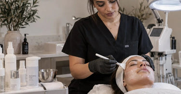 A serene spa treatment room with dim lighting, a comfortable massage table, and a towel steamer, representing the luxury of a silent appointment experience
