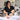 A beauty student or professional sanitizing a training mannequin and practice hand with spray and cloth, emphasizing proper disinfection and hygiene for salon and spa training tools.