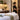 Quiet professional spa treatment room door with a peaceful massage room and clean linens