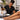 Professional esthetician applying body wax during a salon waxing treatment, illustrating why wax cools and sets at different speeds on certain body areas