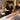 Professional esthetician performing large area waxing in a warm spa treatment room