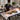 Esthetician adjusting the leg support section of a professional waxing table for better client comfort and ergonomic positioning