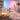 A serene spa setting with soft, ambient colored light therapy illuminating a peaceful treatment room