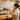 A stylish and well-organized retail wall in a spa or salon, with products like serums, scrubs, and nail polishes displayed at eye level on glass shelves, highlighting the concept of 'eye level is buy level' for effective merchandising.