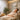 A serene and softly lit quiet room in a salon or spa, featuring a plush armchair, warm lighting, and a calm, minimalist decor to help overstimulated clients relax.