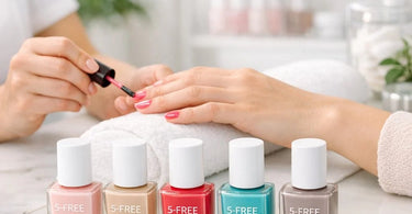 A manicurist applying 5-free or 10-free nail polish to a client's nails in a clean, modern salon setting