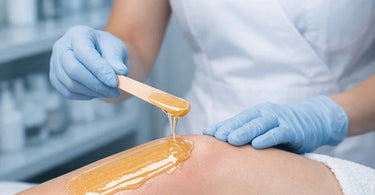 Winter waxing problems: close up of dry, flaking skin with lifted wax edges and redness, with professional pre-wax oil and hydrating hard wax products from Pure Spa Direct nearby.