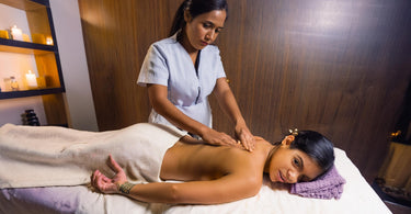 Woman receiving a deep tissue massage therapy treatment at a spa