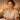 A serene spa professional taking a calming breath in a peaceful treatment room, symbolizing nervous system regulation.